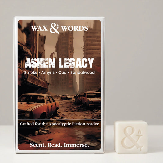 Wax & Words 'Ashen Legacy' candle packaging shown upright next to a small white wax candle with an ampersand symbol, on a light gray background.