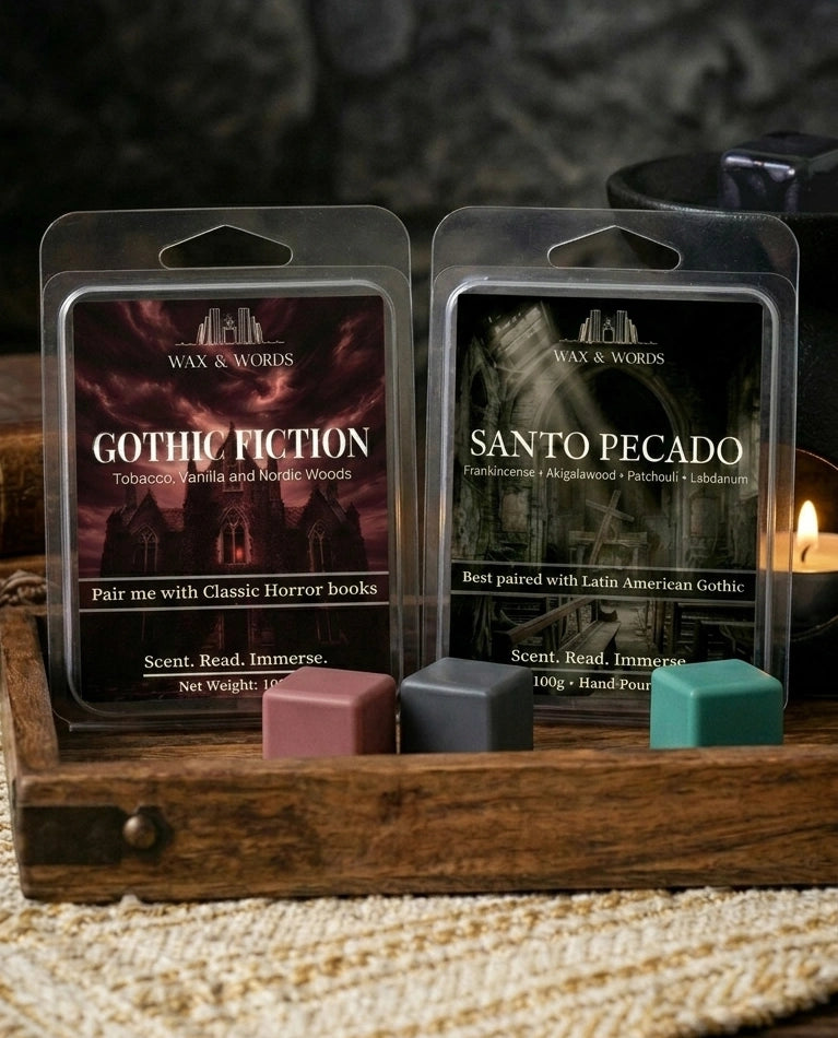 Wax melts in packaging with 'Gothic Fiction' and 'Santo Pecado' labels on a wooden surface.
