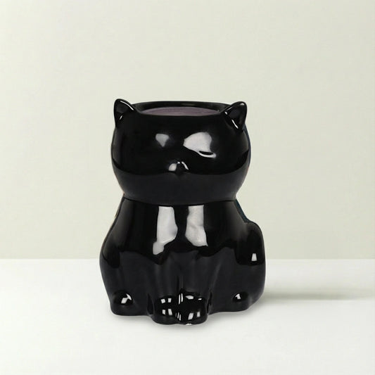 Black cat-shaped container on a beige background