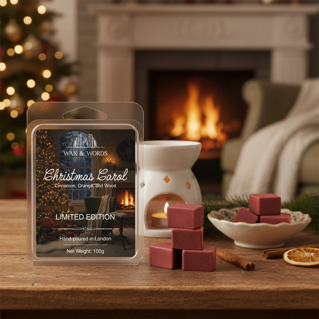 Wax melt package with 'Christmas Carol' scent in front of a fireplace and Christmas tree.