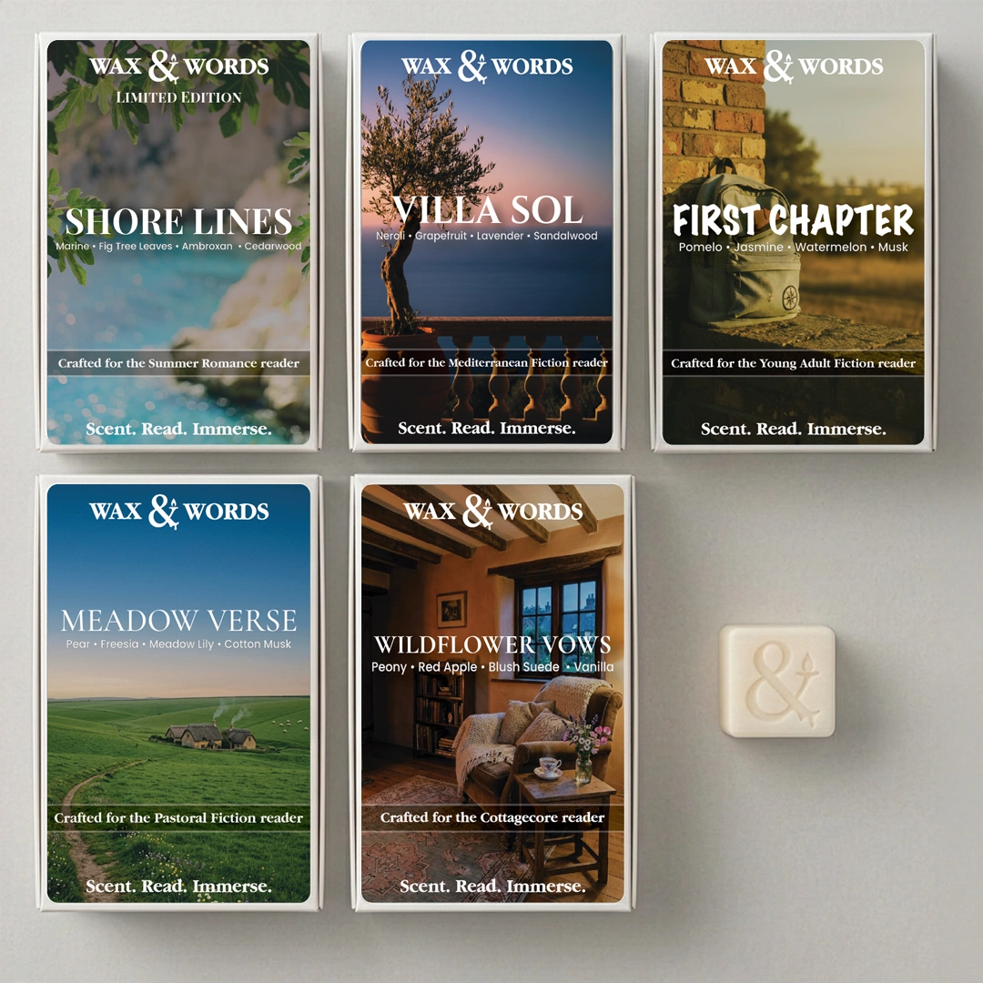 Six Wax & Words limited edition booklets for summer, winter, and pastime readers are arranged on a gray background, with a small cream-colored soap bar featuring an ampersand symbol next to them.