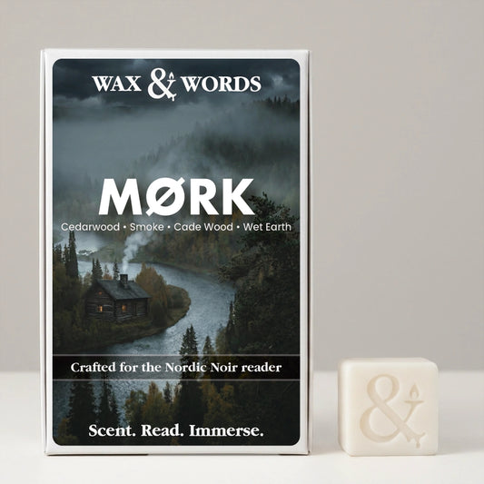 A boxed fragrance product labeled WAX & WORDS MØRK stands upright against a light gray background, with a small off-white wax cube beside it. The box features a dark moody forest and river scene, and the wax cube has an embossed ampersand symbol.