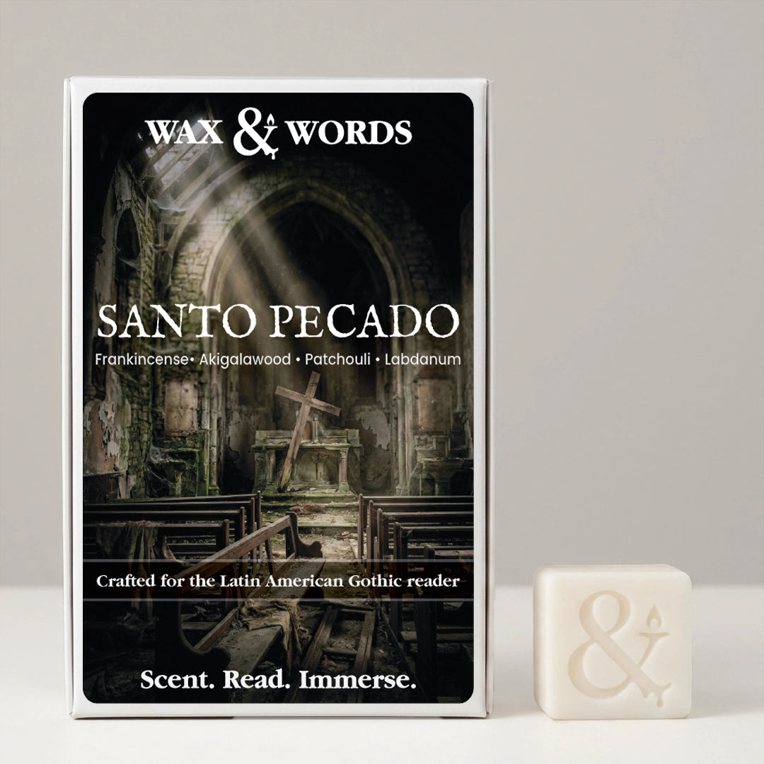 Wax & Words 'Santo Pecado' scented candle box shown next to a small cream-colored candle cube with an ampersand symbol, on a light gray background.