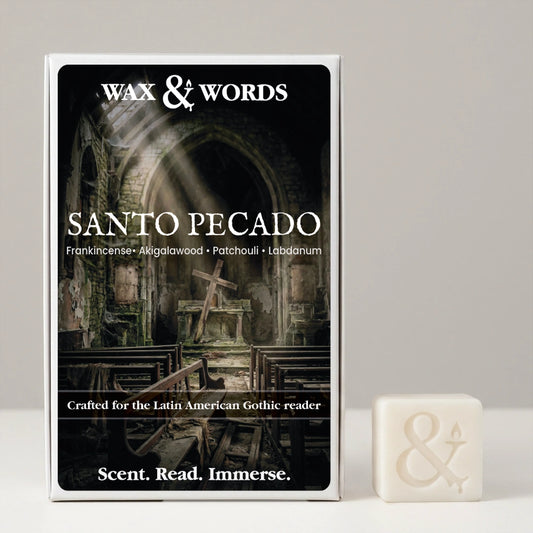 Wax & Words 'Santo Pecado' scented candle box shown next to a small cream-colored candle cube with an ampersand symbol, on a light gray background.