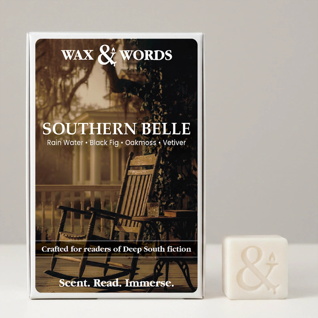 Wax & Words 'Southern Belle' scented candle in its illustrated box, shown next to a small white candle cube with an ampersand symbol on a light gray background.