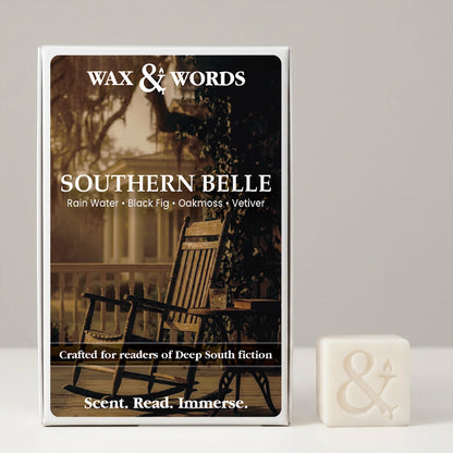 Wax & Words 'Southern Belle' scented candle in its illustrated box, shown next to a small white candle cube with an ampersand symbol on a light gray background.