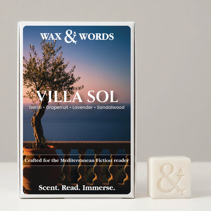 Wax & Words 'Villa Sol' fragrance box shown upright next to a small white bar of soap with an ampersand symbol, on a light gray background.