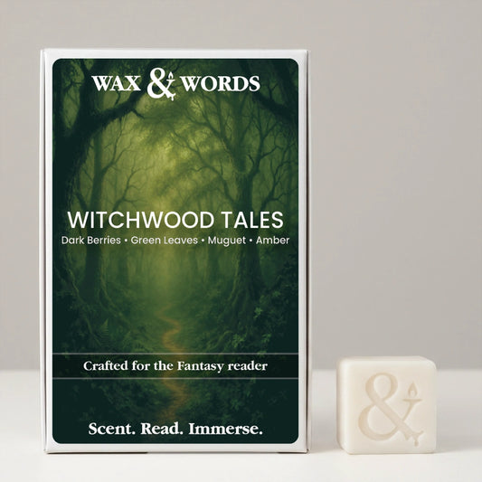 Wax & Words Witchwood Tales scented candle packaging box shown next to a small cream-colored candle with an ampersand symbol, on a neutral light gray background.