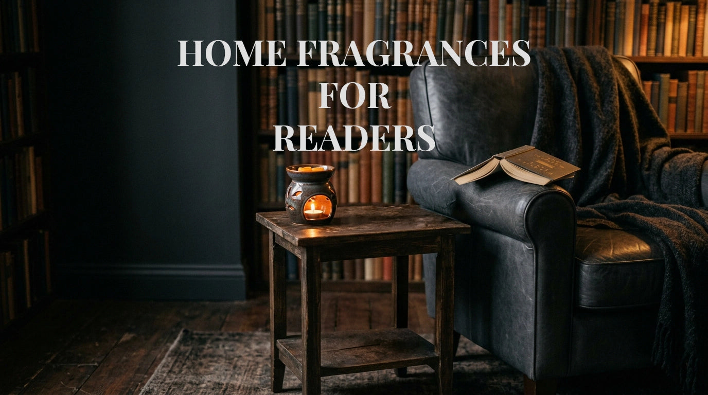 A cozy library or reading room scene with a dark leather armchair draped with a blanket, an open book resting on the chair, a small lit candle holder on a wooden side table, and large text reading “HOME FRAGRANCES FOR READERS” across the top.